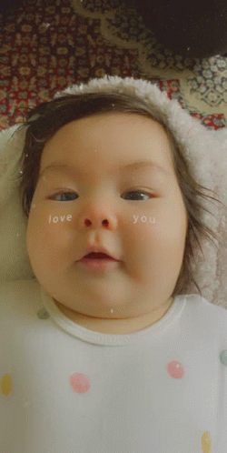 A Baby Has The Words Love You Written On Her Face GIF