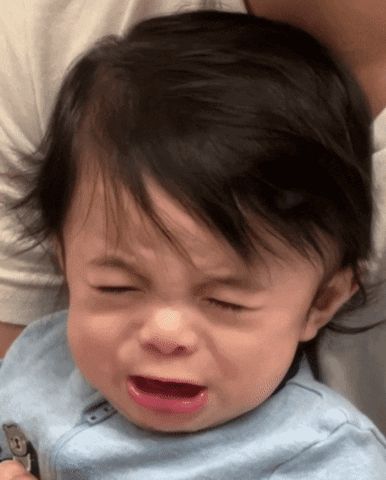 A Baby In A Blue Shirt Is Crying GIF