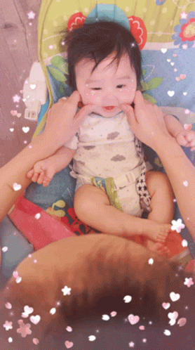 A Baby In A High Chair Being Held By A Person GIF