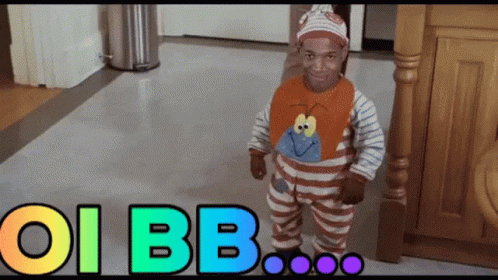 A Baby In A Striped Outfit Is Standing In Front Of A Sign That Says Oi Bb On It GIF