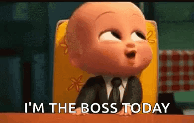 A Baby In A Suit And Tie Is Sitting In A Chair . GIF