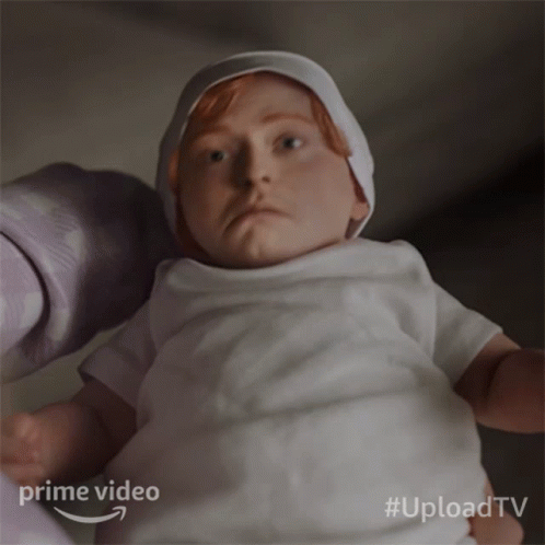 A Baby In A White Shirt Is Being Held By A Person With The Words Prime Video Behind It GIF