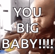 a baby is being held by a person and says `` you big baby !! ''