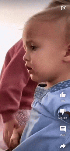 A Baby Is Being Held In Someone 'S Arms With The Number 235 On The Bottom GIF