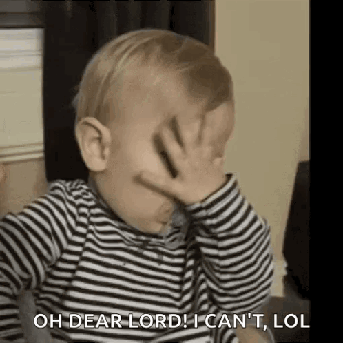 A Baby Is Covering His Face With His Hand . GIF