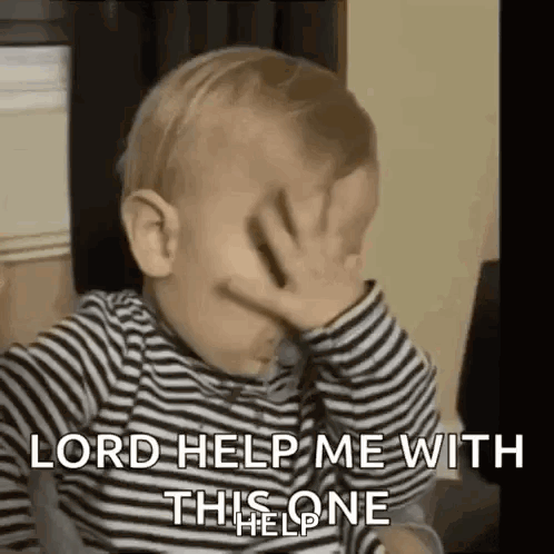 A Baby Is Covering His Face With His Hand . GIF