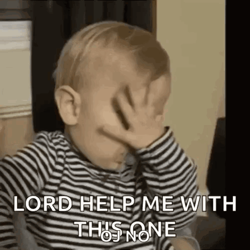 A Baby Is Covering His Face With His Hand . GIF