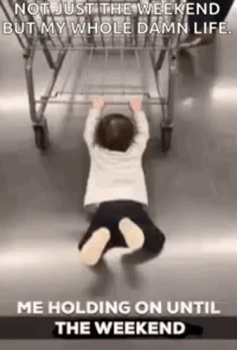 A Baby Is Crawling On The Floor Next To A Shopping Cart . GIF