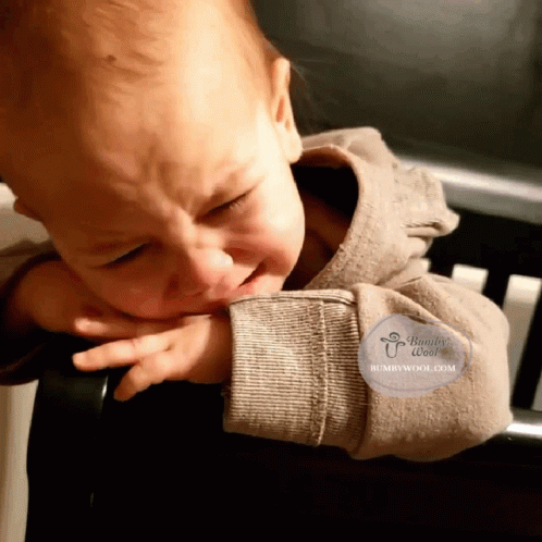 A Baby Is Crying And Has A Humbywool.com Logo On His Arm GIF