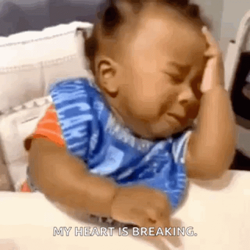 A Baby Is Crying While Sitting At A Table And The Words My Heart Is Breaking Are Visible GIF