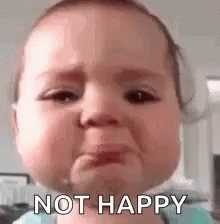 A Baby Is Crying With The Words `` Not Happy '' Written On Its Face . GIF