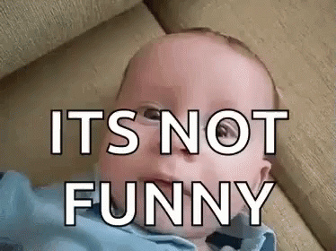A Baby Is Laying On A Couch With The Words `` It 'S Not Funny '' Written On It 'S Face . GIF