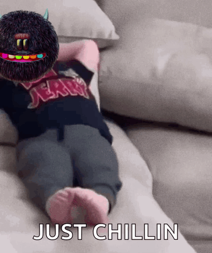 A Baby Is Laying On A Couch With The Words Just Chillin Written On The Bottom GIF