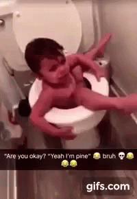 A Baby Is Laying On Top Of A Toilet With A Person Holding It . GIF