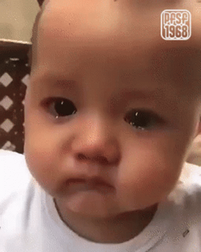 A Baby Is Making A Funny Face And Has The Year 1968 On It GIF
