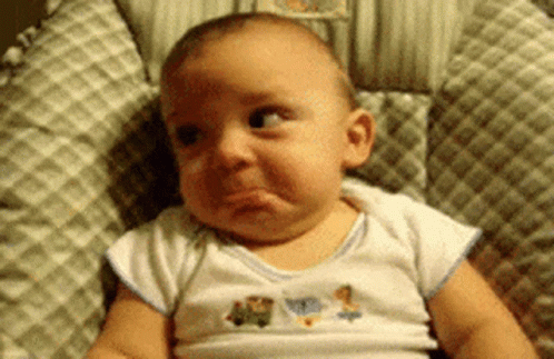 A Baby Is Making A Funny Face While Sitting On A High Chair . GIF