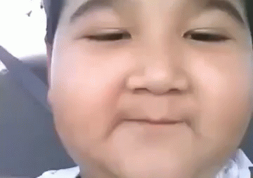 A Baby Is Making A Funny Face With His Eyes Closed And His Mouth Open . GIF