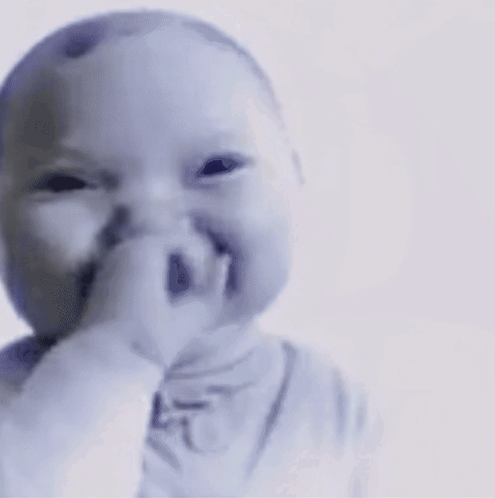 a baby is making a funny face with his finger in his mouth