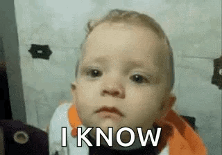 A Baby Is Making A Funny Face With The Words `` I Know '' Written On It . GIF