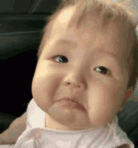A Baby Is Making A Sad Face And Making A Funny Face . GIF