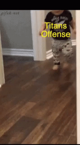 a baby is running down a hallway with the words titans offense written on the bottom