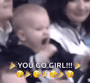 A Baby Is Screaming In A Crowd Of People With The Words `` You Go Girl '' Written On It . GIF