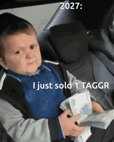 A Baby Is Sitting In A Car Seat Holding A Piece Of Paper That Says 2027 I Just Sold 1 Taggr GIF