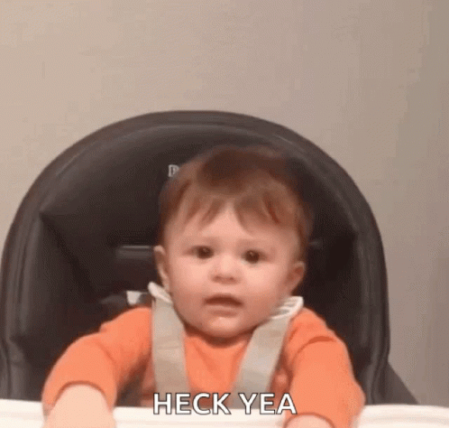 A Baby Is Sitting In A High Chair Making A Funny Face And Saying Heck Yea . GIF