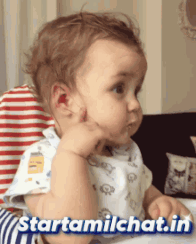 a baby is sitting in a high chair with the words starttamilchat.in below him