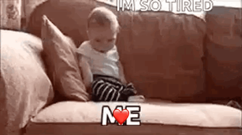 A Baby Is Sitting On A Couch With The Words `` I 'M So Tired Me '' Written On It . GIF