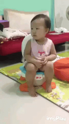 A Baby Is Sitting On A Potty In A Living Room With Imgplay Written On The Bottom Right GIF