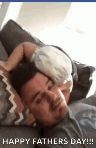 A Baby Is Sleeping On A Man 'S Head . GIF
