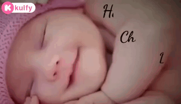 A Baby Is Sleeping On A Pink Pillow With The Words Happy Childr Dr. Written On It . GIF