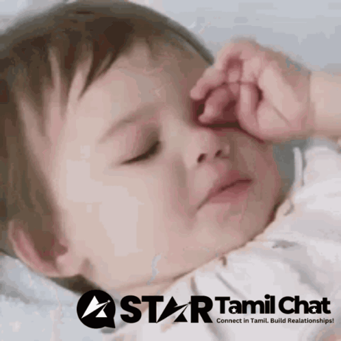 a baby is sleeping with a star tamil chat logo behind it