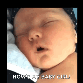 A Baby Is Sleeping With Its Mouth Open And A Person Is Holding It . GIF