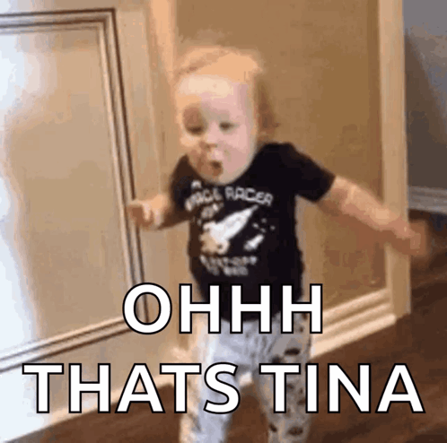 A Baby Is Standing In A Hallway With The Words Ohhh Thats Tina Written On The Wall . GIF