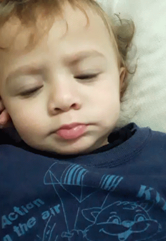A Baby Is Wearing A Blue Shirt That Says Action In The Air GIF