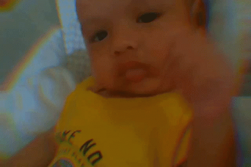 A Baby Is Wearing A Yellow Shirt That Says " Wake No " GIF