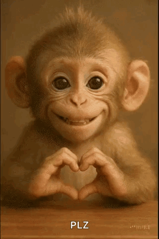 A Baby Monkey Is Smiling And Making A Heart Shape With Its Hands . GIF