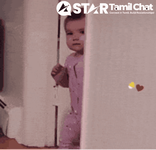 A Baby Peeking Out From Behind A Wall With A Star Tamil Chat Logo Behind It GIF