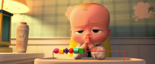 A Baby Sitting In A High Chair With A Bottle Of Baby Powder Behind Him GIF