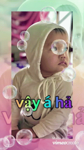 A Baby Surrounded By Soap Bubbles With The Words Vay A Ha GIF