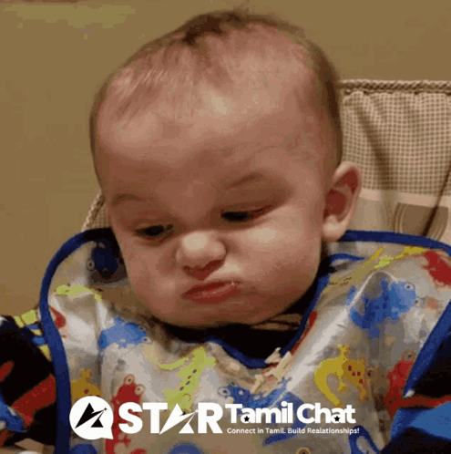 A Baby Wearing A Bib With A Star Tamil Chat Logo On The Bottom GIF