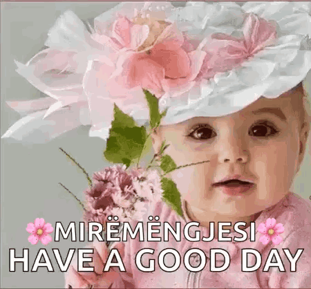 A Baby Wearing A Hat With Flowers On It And A Bouquet Of Flowers . GIF