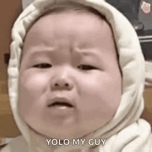 A Baby Wearing A Hooded Sweatshirt Is Crying And Making A Face . GIF