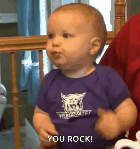 A Baby Wearing A Purple Weber State Shirt Says You Rock GIF