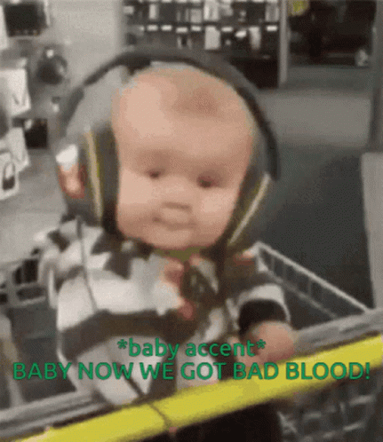 A Baby Wearing Headphones Is In A Shopping Cart With The Words Baby Accent Baby Now We Got Bad Blood GIF