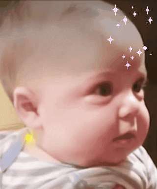 A Baby With Stars On His Forehead Looks At The Camera GIF