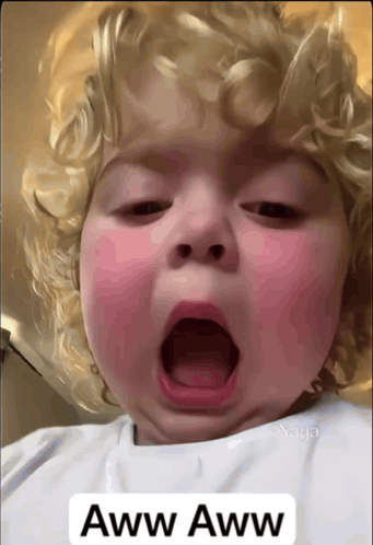 A Baby Yawning With The Words Aww Aww On The Bottom Right GIF