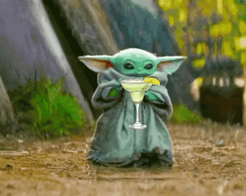 A Baby Yoda Is Holding A Margarita With A Lime Wedge GIF